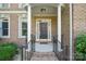 Elegant front entrance with brick columns and wrought iron railings at 12004 New Bond Dr, Huntersville, NC 28078