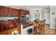 Beautiful kitchen featuring dark cabinets, granite countertops, stainless appliances, and breakfast bar at 12004 New Bond Dr, Huntersville, NC 28078