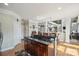 Bright kitchen with dark island with granite countertop, stainless cooktop, and breakfast bar seating at 12004 New Bond Dr, Huntersville, NC 28078