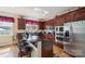 Well-equipped kitchen with cherry wood cabinets, granite counters, and modern stainless steel appliances at 12004 New Bond Dr, Huntersville, NC 28078
