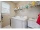 Functional laundry room with washer, dryer, utility sink, and ample shelving at 12004 New Bond Dr, Huntersville, NC 28078