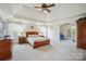 Spacious main bedroom with tray ceiling, fan, and sitting room entrance at 12004 New Bond Dr, Huntersville, NC 28078