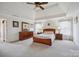 Bright main bedroom with carpet, ceiling fan, and natural light from many windows at 12004 New Bond Dr, Huntersville, NC 28078