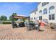 Brick patio featuring a gazebo, outdoor dining area, and view of white sided house with arched windows at 12004 New Bond Dr, Huntersville, NC 28078