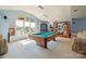 Entertainment room featuring a pool table, window seat with decor, and a display case on blue walls at 12004 New Bond Dr, Huntersville, NC 28078
