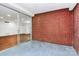 Open-air balcony with brick walls and access to the living room through sliding glass doors at 1300 Queens Rd # 405, Charlotte, NC 28207