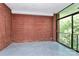 Balcony with brick walls, concrete floor, and sliding glass door to interior at 1300 Queens Rd # 405, Charlotte, NC 28207