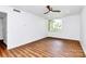 Bright bedroom with modern ceiling fan and large window views of the outdoors at 1300 Queens Rd # 405, Charlotte, NC 28207