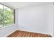 Sunlit bedroom featuring a large window with tree views and neutral wall paint at 1300 Queens Rd # 405, Charlotte, NC 28207
