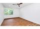 Spacious bedroom with large window providing natural light and vinyl wood flooring at 1300 Queens Rd # 405, Charlotte, NC 28207