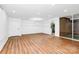Spacious living room with hardwood floors, neutral paint and access to balcony via sliding glass doors at 1300 Queens Rd # 405, Charlotte, NC 28207