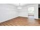 Bright living room with hardwood floors, storage and access to balcony via sliding glass doors at 1300 Queens Rd # 405, Charlotte, NC 28207