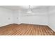 Living room with hardwood floors, contemporary light fixture, and white walls at 1300 Queens Rd # 405, Charlotte, NC 28207