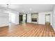 Open living room with hardwood floors, stylish light fixture and a sliding glass door to a balcony at 1300 Queens Rd # 405, Charlotte, NC 28207