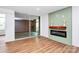 Living room featuring a modern fireplace with shiplap accent, hardwood floors and sliding glass doors at 1300 Queens Rd # 405, Charlotte, NC 28207