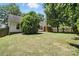 Grassy backyard with lush green grass, a tall privacy fence, and the rear of a white house at 14658 Laura Michelle Rd, Huntersville, NC 28078
