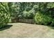 Well-maintained backyard featuring healthy green grass, mature bushes and a tall wooden fence at 14658 Laura Michelle Rd, Huntersville, NC 28078