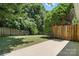 This backyard features a lush lawn, mature trees, and a privacy fence, perfect for outdoor entertaining at 14658 Laura Michelle Rd, Huntersville, NC 28078