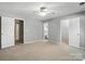 Comfortable bedroom with neutral tones, fan, closet, and access to a full ensuite bathroom at 14658 Laura Michelle Rd, Huntersville, NC 28078