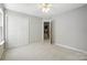 Inviting bedroom with carpet, a ceiling fan and closet, with easy access to laundry area at 14658 Laura Michelle Rd, Huntersville, NC 28078