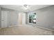 Spacious bedroom with neutral walls, plush carpet, and a walk-in closet at 14658 Laura Michelle Rd, Huntersville, NC 28078