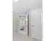 Hallway view of neutral walls with access to an ensuite bathroom and bedroom at 14658 Laura Michelle Rd, Huntersville, NC 28078