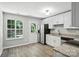 Eat-in kitchen with granite countertops, stainless steel appliances, ample windows and wood-look floors at 14658 Laura Michelle Rd, Huntersville, NC 28078