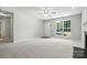 Bright living room featuring neutral walls, large window, ceiling fan, and inviting fireplace at 14658 Laura Michelle Rd, Huntersville, NC 28078