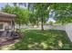Expansive backyard with lush lawn, mature trees, privacy fence, and features like a hammock at 14747 Pomerol Ln, Pineville, NC 28134