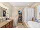 Elegant bathroom with dual vanity, soaking tub, shower, and walk-in closet at 14747 Pomerol Ln, Pineville, NC 28134