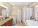 Elegant bathroom with soaking tub, shower, granite counters, and updated fixtures at 14747 Pomerol Ln, Pineville, NC 28134