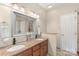Bright bathroom with double vanity sinks, granite countertop and neutral tile floors at 14747 Pomerol Ln, Pineville, NC 28134