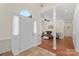 Bright foyer featuring tile flooring, a glass-paneled front door, and an open view of the living spaces at 14747 Pomerol Ln, Pineville, NC 28134
