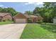 Charming single-story brick home with well-maintained landscaping, a manicured lawn and paved driveway at 14747 Pomerol Ln, Pineville, NC 28134