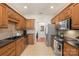 Traditional kitchen showcasing cherry cabinets, stainless steel appliances, and black countertops at 14747 Pomerol Ln, Pineville, NC 28134