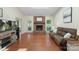 Open living area with a brick fireplace, hardwood floors, and ample space for entertainment and relaxation at 14747 Pomerol Ln, Pineville, NC 28134