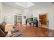 Spacious living room filled with natural light, hardwood floors, and stylish furniture, with an open layout at 14747 Pomerol Ln, Pineville, NC 28134