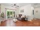 Cozy living area with a large window providing ample natural light and hardwood floors throughout the room at 14747 Pomerol Ln, Pineville, NC 28134