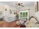 Inviting living room featuring hardwood floors, neutral paint, large window, and comfortable seating furniture at 14747 Pomerol Ln, Pineville, NC 28134