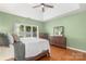Light-filled main bedroom boasts hardwood floors and a large window for ample natural light at 14747 Pomerol Ln, Pineville, NC 28134