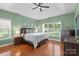 Inviting main bedroom with tray ceiling, hardwood floors, and ample natural light at 14747 Pomerol Ln, Pineville, NC 28134