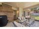 Covered patio with comfortable seating and brick fireplace at 14747 Pomerol Ln, Pineville, NC 28134
