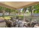 Screened porch with comfortable seating and views of backyard at 14747 Pomerol Ln, Pineville, NC 28134