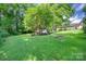 Spacious backyard with mature trees, a gazebo, and a fire pit offering a serene outdoor living space at 1498 Legion Rd, Fort Mill, SC 29715