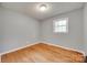 A cozy bedroom featuring hardwood floors, neutral gray walls, and a bright window at 1498 Legion Rd, Fort Mill, SC 29715