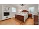 Spacious bedroom with hardwood floors, a decorative fireplace, and plenty of natural light at 1498 Legion Rd, Fort Mill, SC 29715