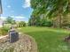 An expansive backyard view with a lush lawn and well-maintained landscape and some HVAC equipment at 1605 Ambergate Dr, Waxhaw, NC 28173