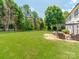 This backyard offers an expansive lawn area, perfect for outdoor activities and relaxation. Also features a pergola at 1605 Ambergate Dr, Waxhaw, NC 28173