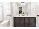 Bathroom with a double sink vanity, a large mirror, and a separate toilet and shower room at 1605 Ambergate Dr, Waxhaw, NC 28173