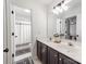Bright bathroom boasts dual sinks, tile flooring, and a shower-tub combination at 1605 Ambergate Dr, Waxhaw, NC 28173